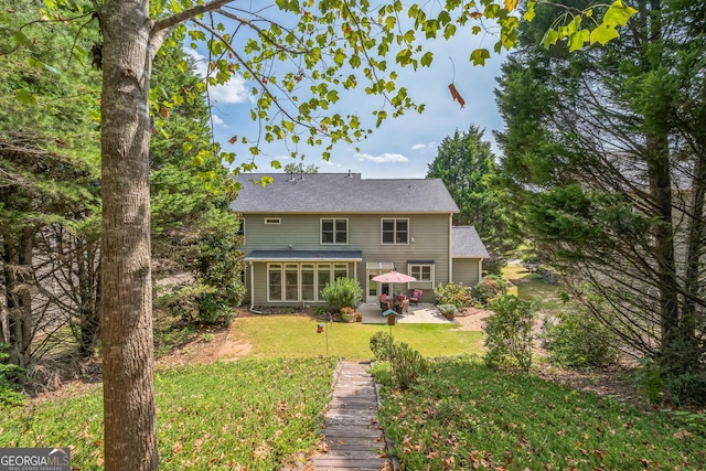 rear view of property with a gazebo, a yard, and a patio area