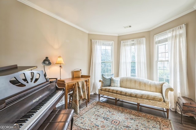 sitting room with crown molding and dark wood-type flooring