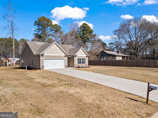 single story home featuring cooling unit, a garage, and a front yard