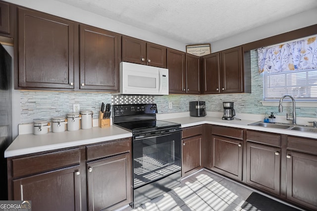 kitchen with black range with electric stovetop, sink, dark brown cabinetry, and decorative backsplash