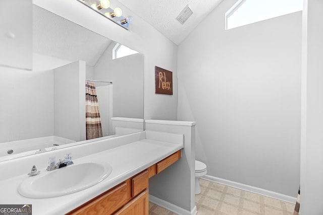 bathroom with lofted ceiling, toilet, a textured ceiling, vanity, and a shower with shower curtain