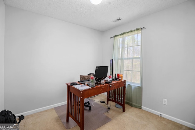 office area featuring light colored carpet and a textured ceiling