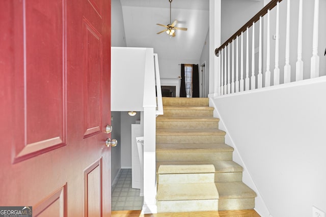 foyer featuring vaulted ceiling and ceiling fan