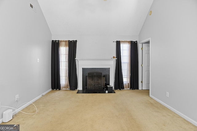 unfurnished living room featuring light colored carpet and high vaulted ceiling