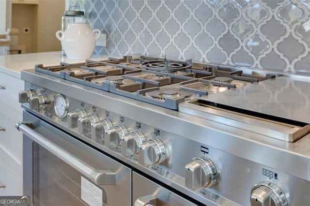 interior details featuring light countertops and high end stove