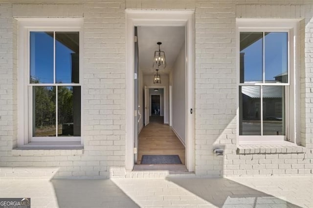 entrance to property featuring brick siding