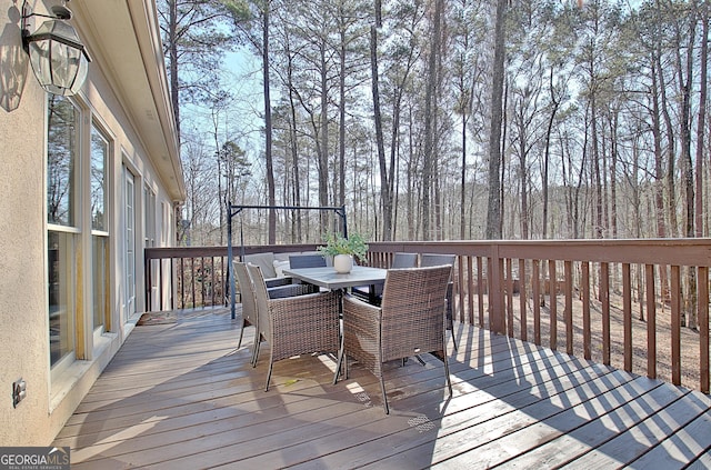 wooden deck featuring outdoor dining area