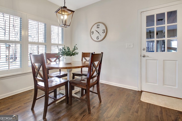 dining area with a chandelier, plenty of natural light, and dark wood-type flooring