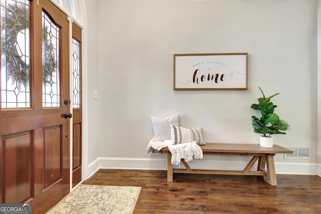 entrance foyer featuring visible vents, baseboards, and dark wood-style floors