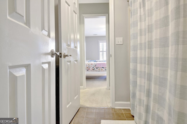 bathroom featuring baseboards and tile patterned flooring