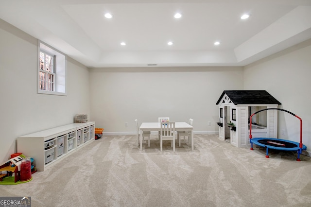 recreation room featuring recessed lighting, a raised ceiling, carpet flooring, and baseboards