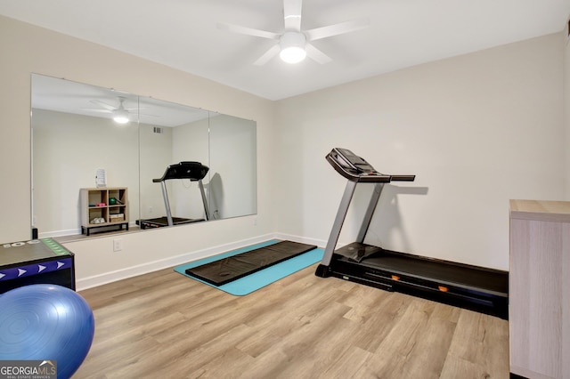 workout room with baseboards, wood finished floors, and ceiling fan