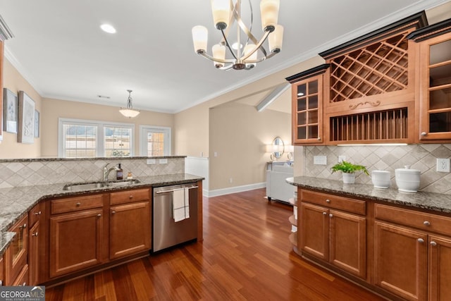 kitchen featuring dark hardwood / wood-style floors, stone countertops, decorative light fixtures, dishwasher, and sink