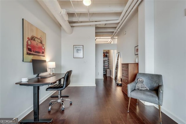 home office with dark hardwood / wood-style floors and beamed ceiling