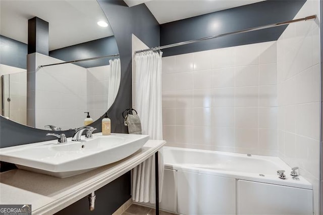 bathroom featuring shower / bathtub combination with curtain and sink