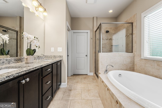 bathroom with vanity, tile patterned floors, and plus walk in shower