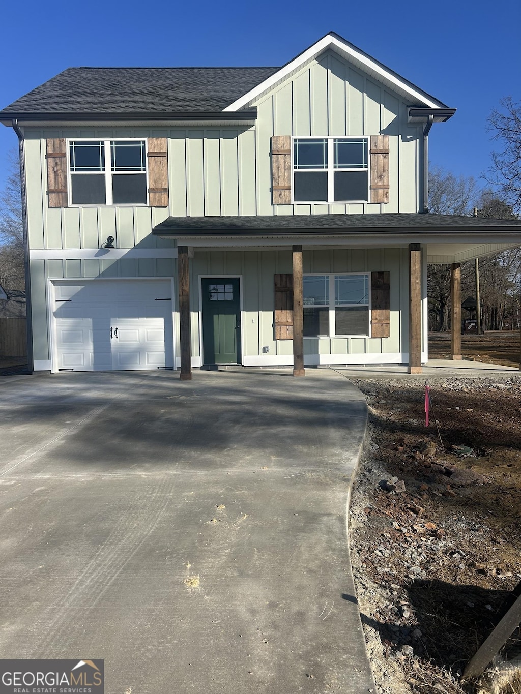 view of front of home with a garage and covered porch