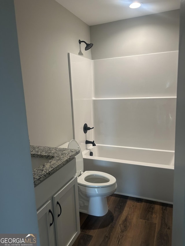 full bathroom with vanity, wood-type flooring, tub / shower combination, and toilet