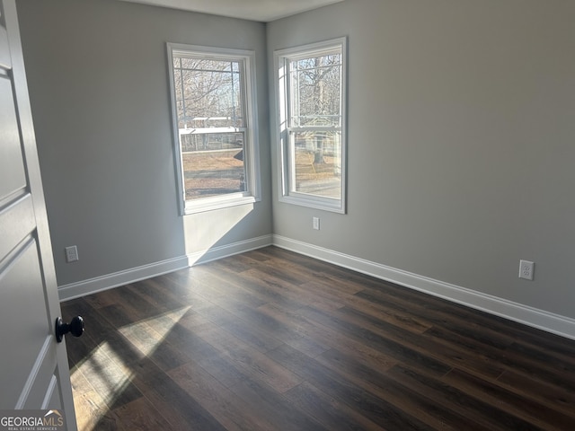 empty room with dark wood-type flooring