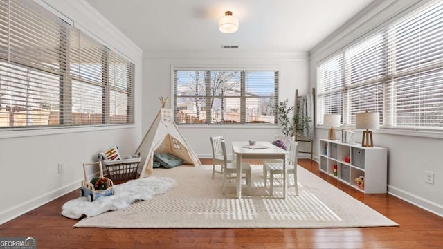 interior space with crown molding and wood-type flooring