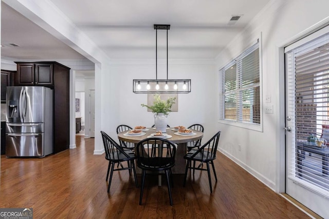 dining space featuring dark hardwood / wood-style flooring and ornamental molding