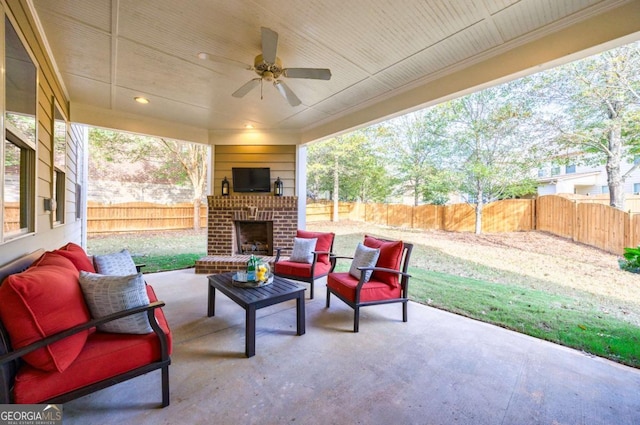 view of patio / terrace featuring an outdoor living space with a fireplace and ceiling fan