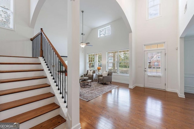 entrance foyer featuring a high ceiling, wood-type flooring, and ceiling fan