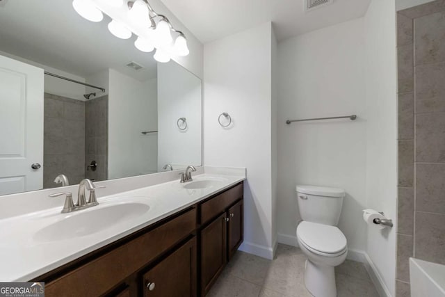 bathroom with tiled shower, tile patterned floors, vanity, and toilet