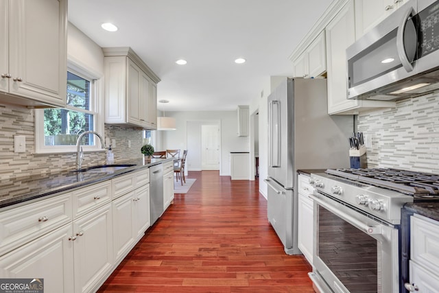 kitchen featuring dark wood-type flooring, appliances with stainless steel finishes, sink, and white cabinets