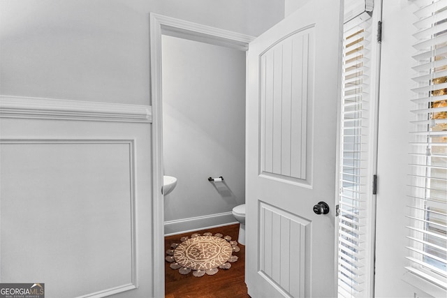 bathroom with wood-type flooring and toilet