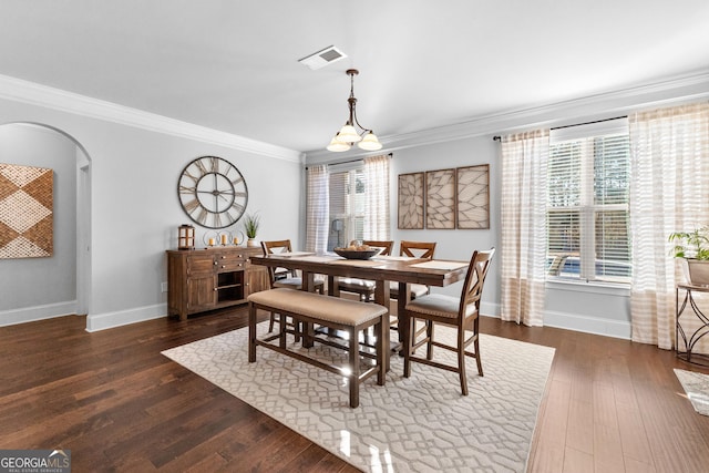 dining area featuring crown molding and dark hardwood / wood-style floors