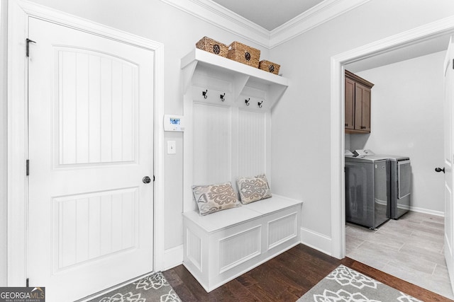 mudroom featuring wood-type flooring, crown molding, and washer and clothes dryer