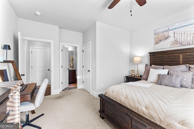 carpeted bedroom with ensuite bath and ceiling fan