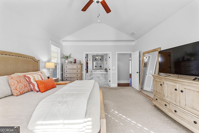 carpeted bedroom with ceiling fan, ensuite bath, and lofted ceiling