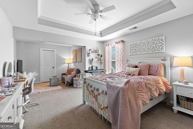 bedroom featuring ornamental molding, a raised ceiling, ceiling fan, and carpet flooring