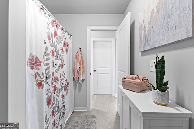 bathroom featuring tile patterned flooring and curtained shower