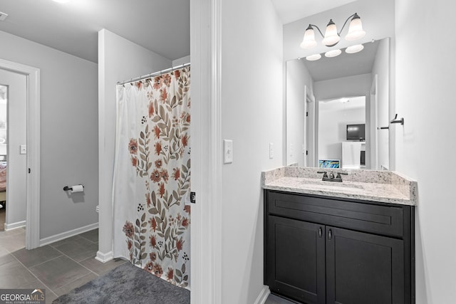 bathroom featuring tile patterned flooring, vanity, and curtained shower