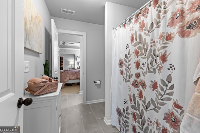 bathroom featuring curtained shower and tile patterned flooring