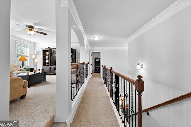 hallway featuring light carpet and ornamental molding