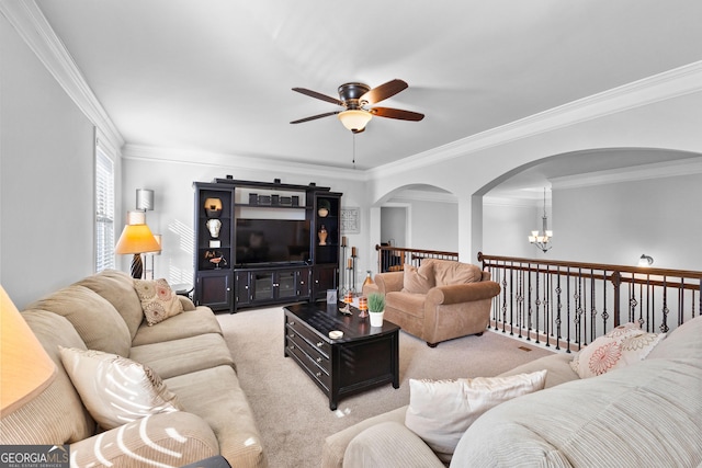 carpeted living room featuring ornamental molding and ceiling fan with notable chandelier