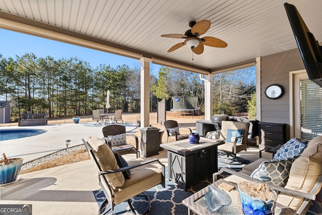 view of patio / terrace with an outdoor hangout area, a trampoline, and ceiling fan