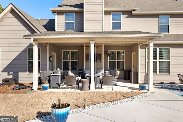 back of property featuring an outdoor living space, ceiling fan, and a patio area