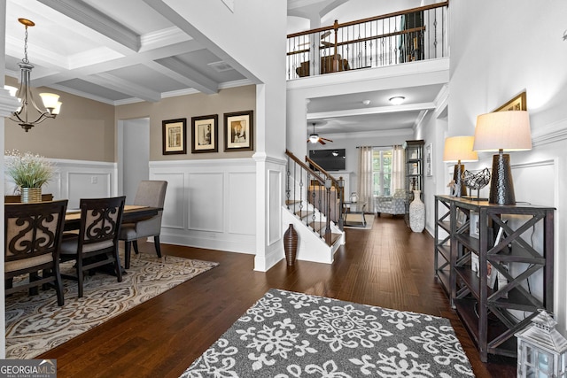 foyer with beamed ceiling, ornamental molding, coffered ceiling, and dark hardwood / wood-style flooring