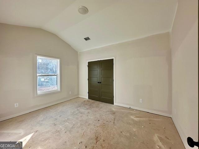 unfurnished bedroom featuring vaulted ceiling