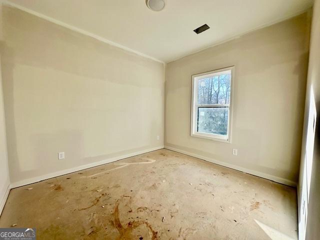 unfurnished room featuring concrete flooring