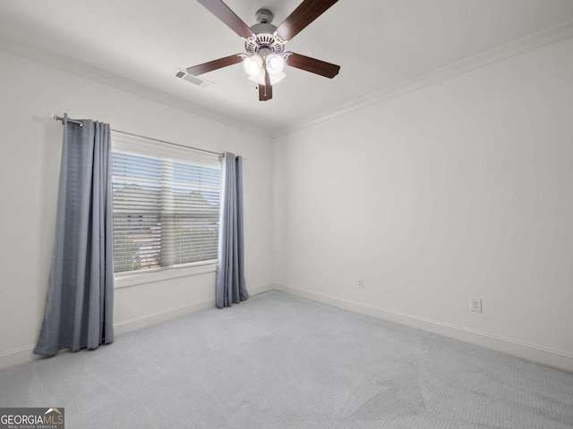 empty room with ornamental molding, light carpet, and ceiling fan