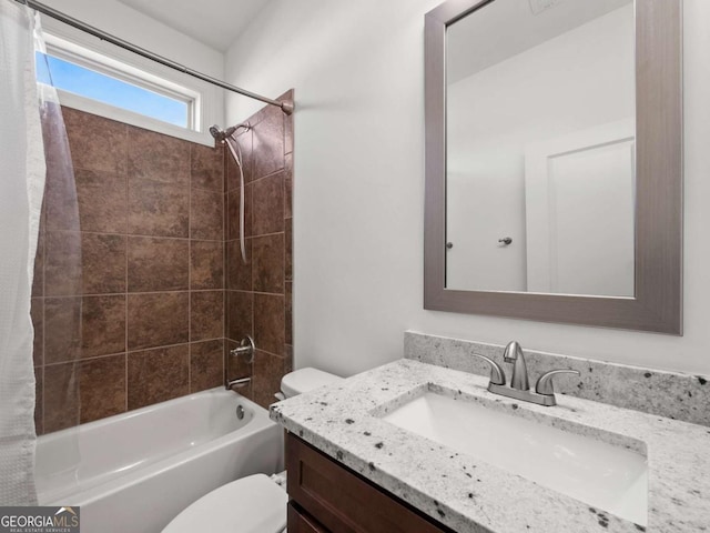 full bathroom featuring vanity, toilet, and tiled shower / bath combo