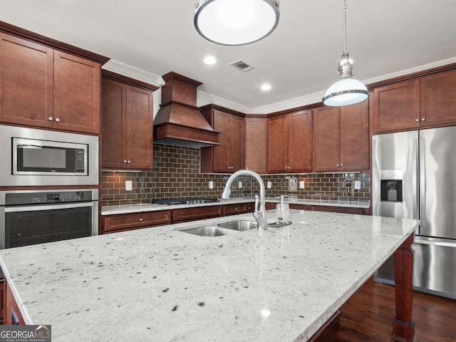 kitchen with sink, dark hardwood / wood-style flooring, custom exhaust hood, light stone counters, and stainless steel appliances
