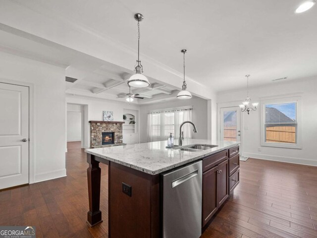 kitchen with stainless steel dishwasher, dark hardwood / wood-style flooring, a kitchen island with sink, and sink