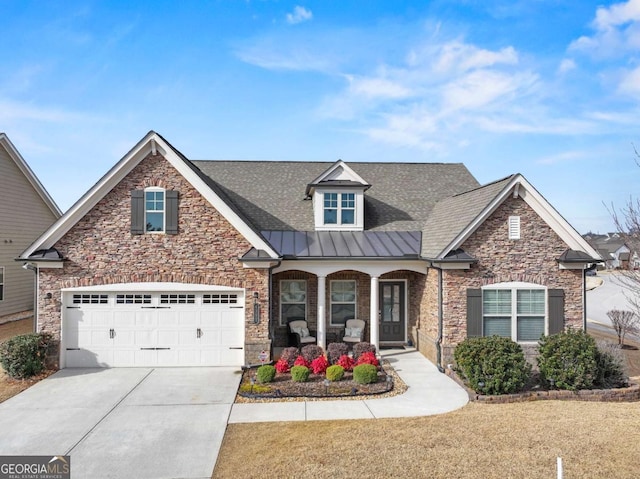 craftsman inspired home with a garage and covered porch